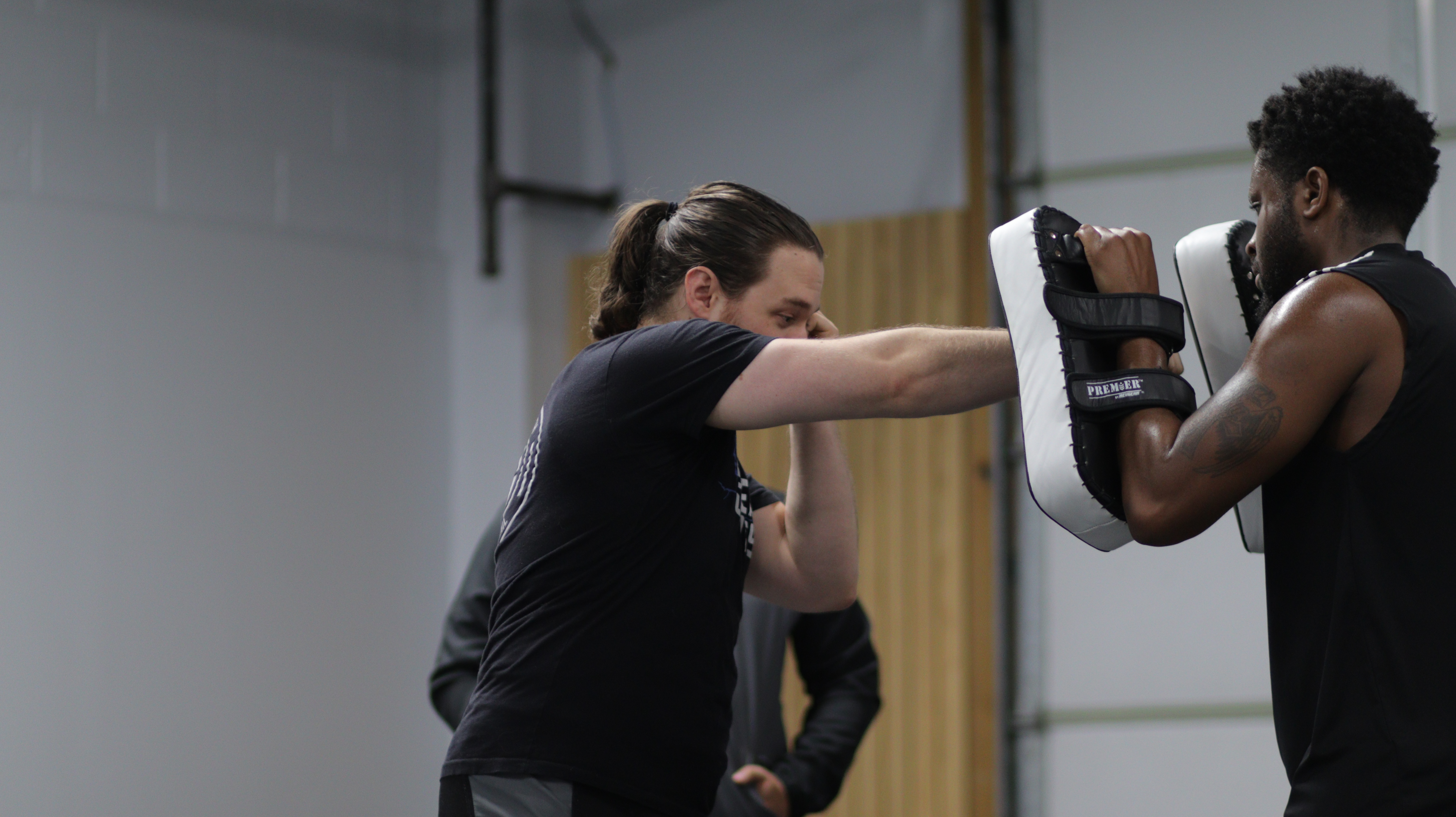 Griffin throwing a punch in Muay Thai Kickboxing class.