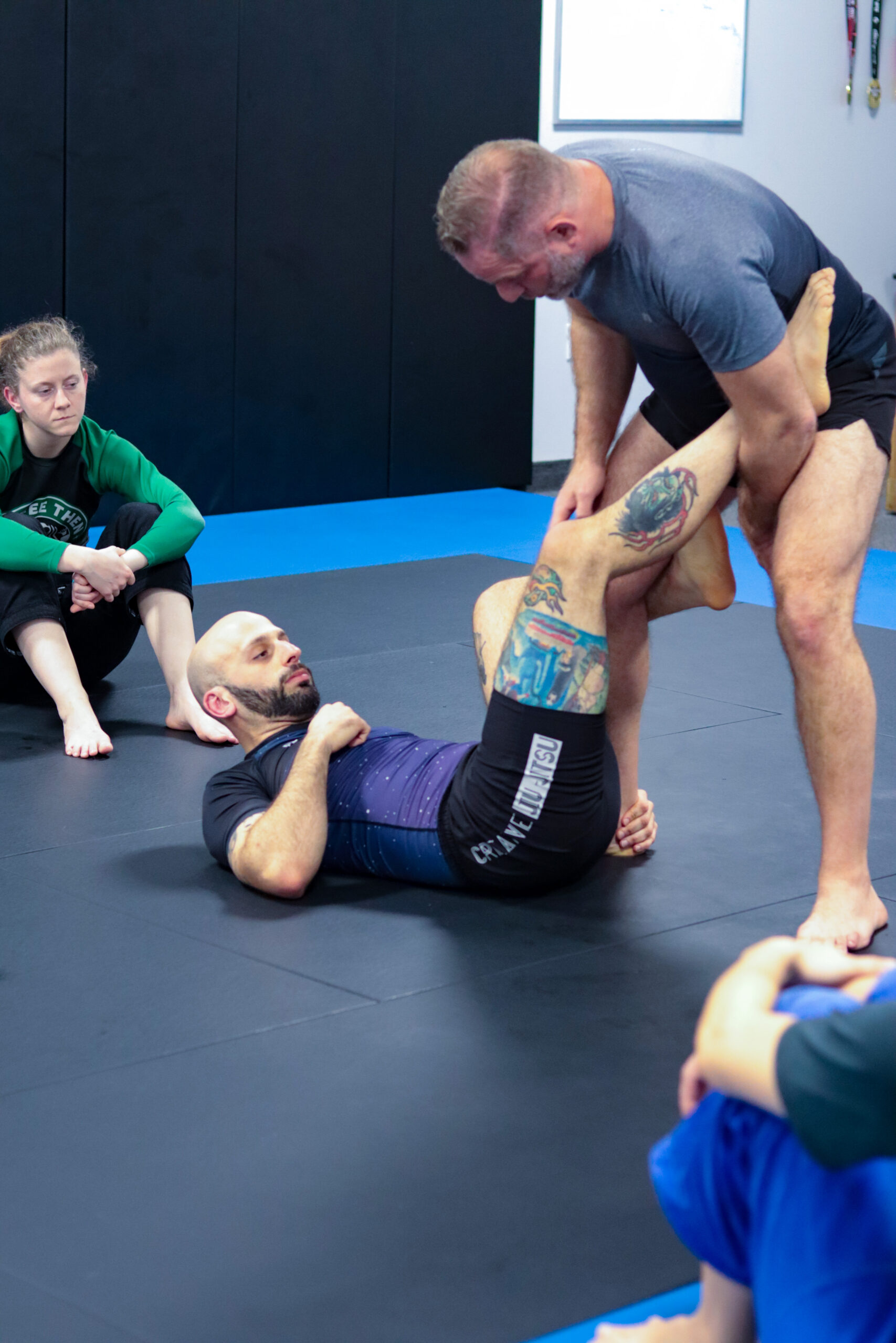 Demonstrating a technique on the mat